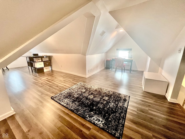 additional living space with lofted ceiling and hardwood / wood-style flooring