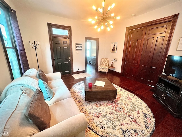 living room featuring a chandelier and dark hardwood / wood-style flooring