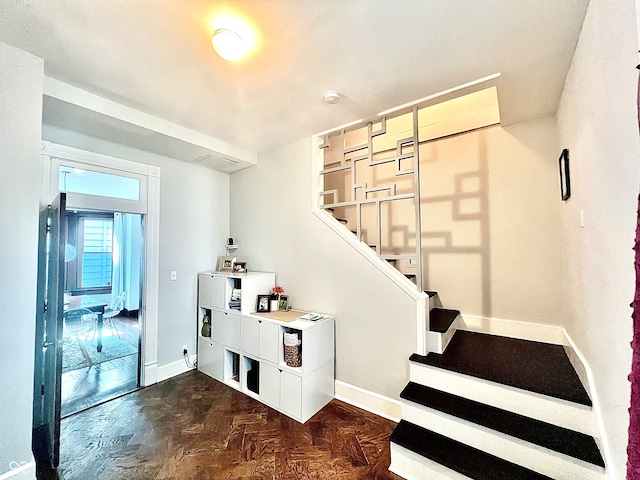 stairs featuring parquet floors