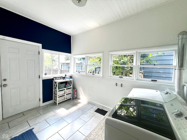 interior space with light tile patterned floors and separate washer and dryer