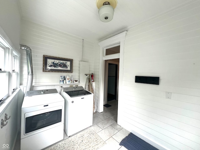 clothes washing area featuring separate washer and dryer and light tile patterned flooring