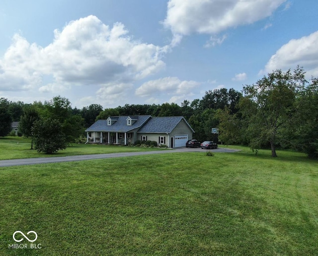 single story home featuring an attached garage, a front lawn, and aphalt driveway