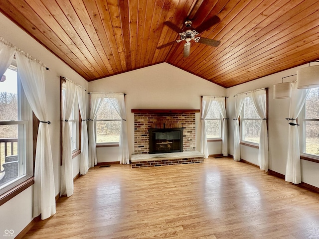 unfurnished living room with lofted ceiling, wooden ceiling, a fireplace, baseboards, and light wood-type flooring