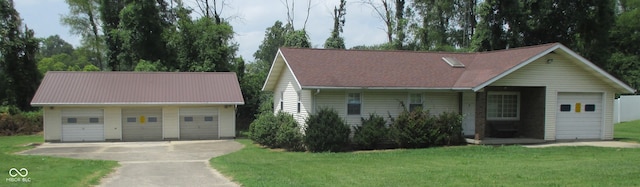 view of front of property featuring a garage and a front yard