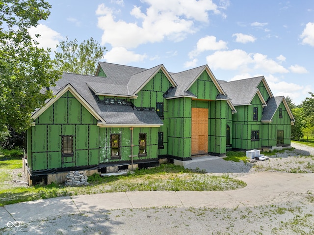 view of front of house featuring roof with shingles and board and batten siding