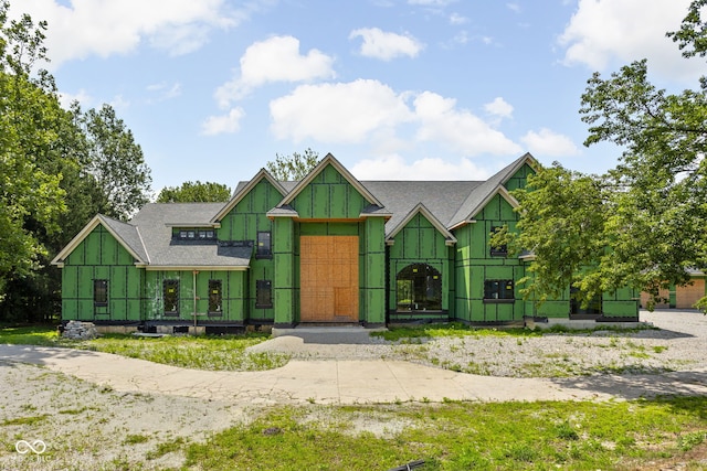 view of front of property featuring a shingled roof and a gate