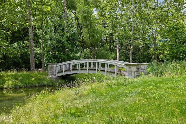 exterior space with a water view and a forest view