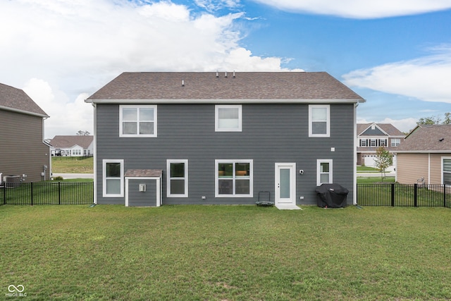 rear view of house featuring a lawn