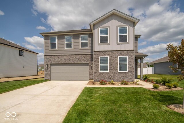 view of front of property with a front lawn and a garage