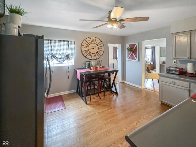 dining room featuring light hardwood / wood-style floors and ceiling fan