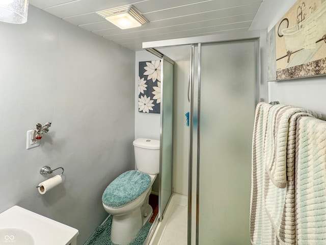 bathroom featuring an enclosed shower and toilet