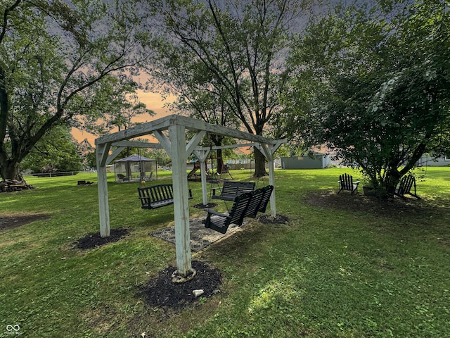 yard at dusk with a gazebo