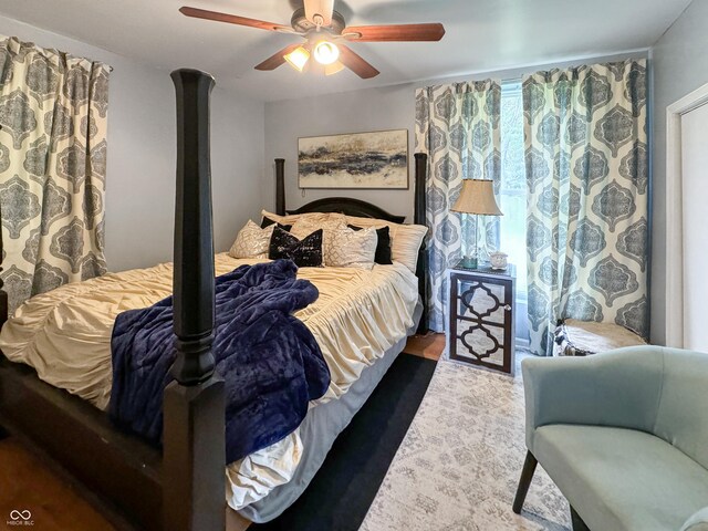 bedroom with ornate columns and ceiling fan