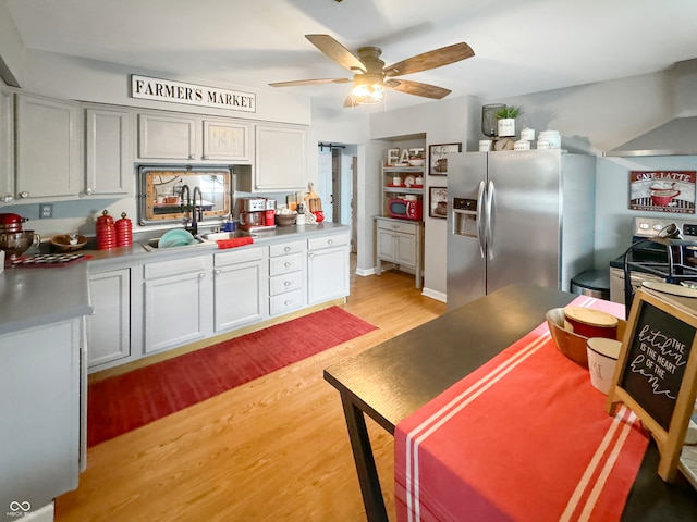 kitchen featuring sink, ceiling fan, light wood-type flooring, and stainless steel appliances