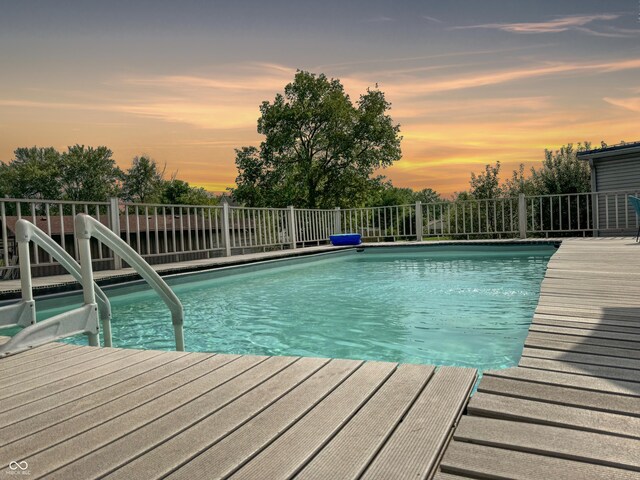 view of pool at dusk