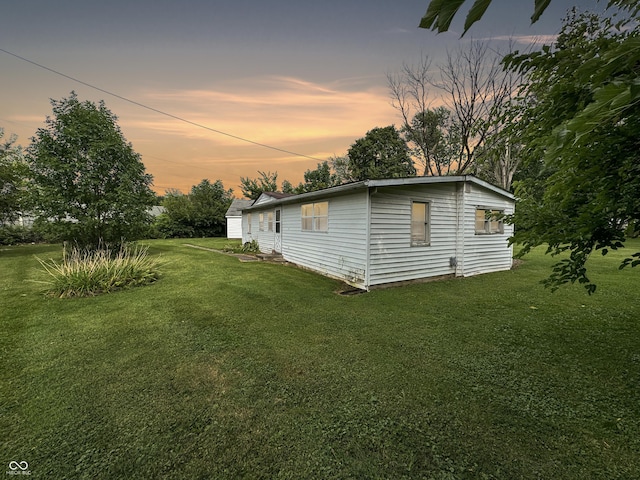 5647 W Mooresville Rd, Indianapolis, IN 46221 - property exterior at dusk featuring a lawn