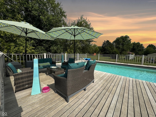 5647 W Mooresville Rd, Indianapolis, IN 46221 - pool at dusk featuring outdoor lounge area and a deck