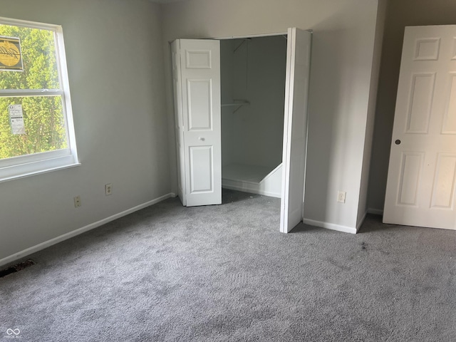 unfurnished bedroom featuring carpet flooring and a closet