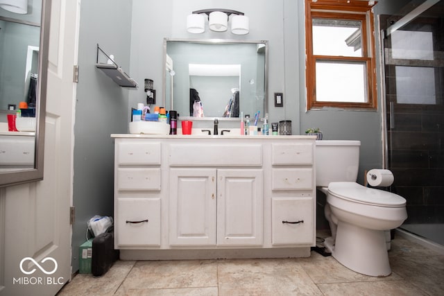 bathroom featuring a shower with shower door, tile patterned floors, toilet, and vanity