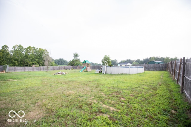 view of yard with a fenced in pool