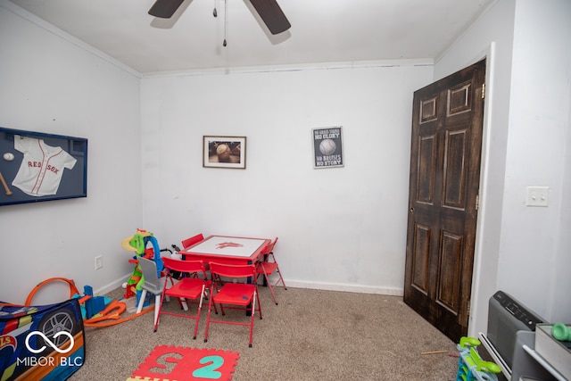 game room with carpet, ceiling fan, and ornamental molding