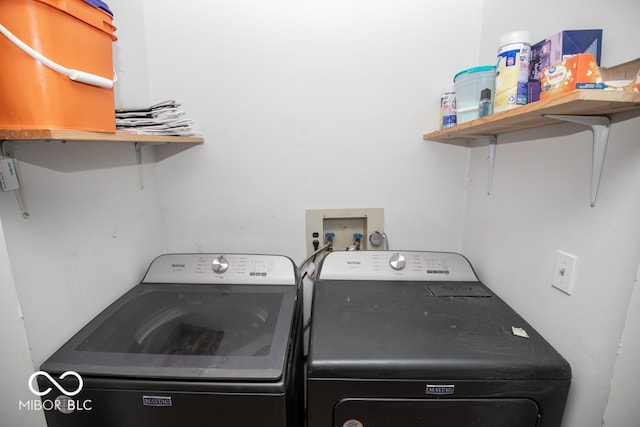 clothes washing area featuring washer and dryer