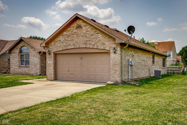 view of front of property with a garage, central AC, and a front lawn