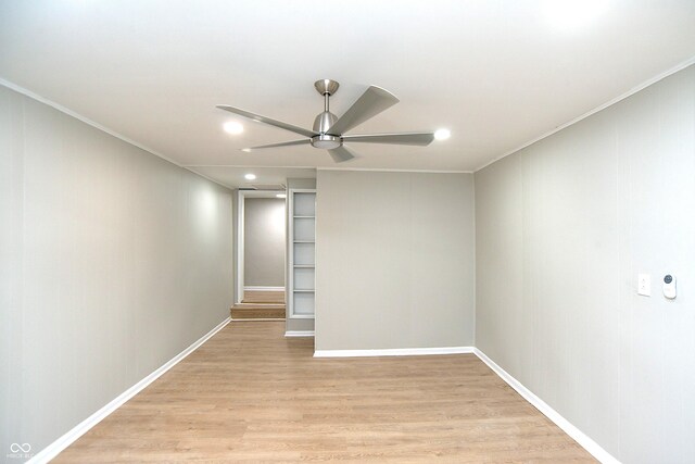 spare room with ceiling fan, ornamental molding, and light hardwood / wood-style floors