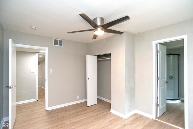 unfurnished bedroom featuring light wood-type flooring, a closet, and ceiling fan