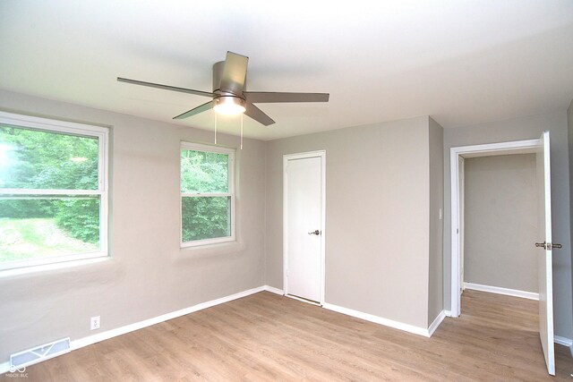 unfurnished bedroom with ceiling fan and light hardwood / wood-style flooring