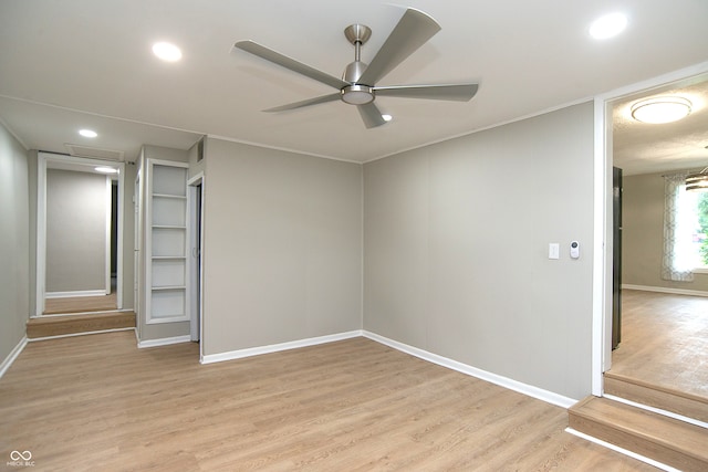 unfurnished room featuring ceiling fan and light wood-type flooring