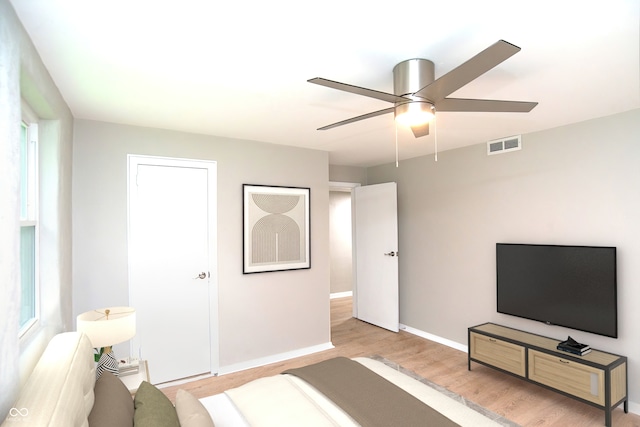 bedroom with ceiling fan and light wood-type flooring