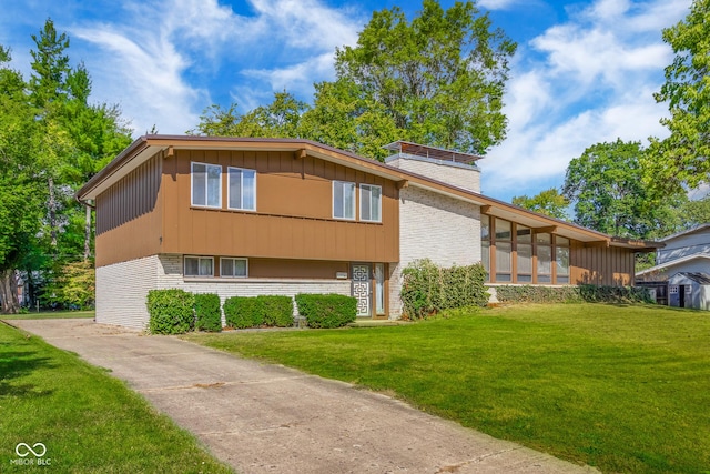 view of side of property with brick siding and a lawn