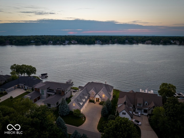 aerial view at dusk with a water view