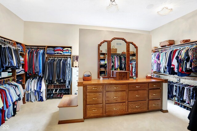 walk in closet featuring light carpet