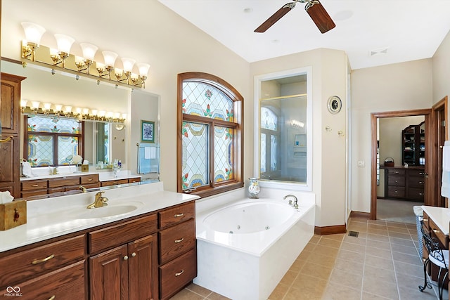 bathroom with ceiling fan, vanity, plus walk in shower, and a healthy amount of sunlight