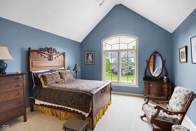 bedroom featuring vaulted ceiling and light colored carpet