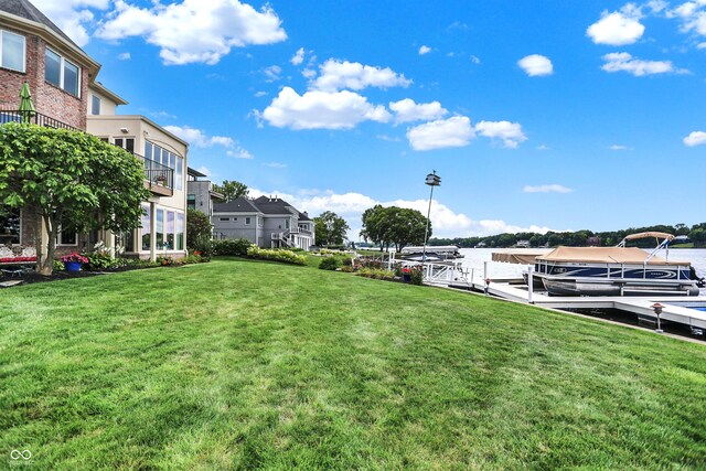 view of yard featuring a balcony and a boat dock