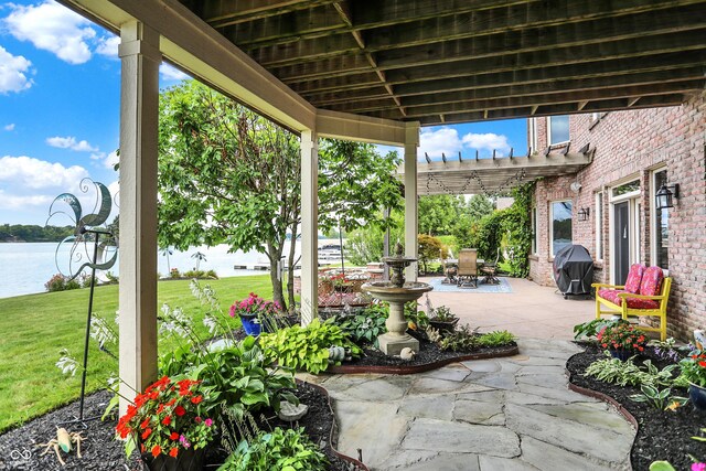 view of patio / terrace featuring a water view, area for grilling, and a pergola