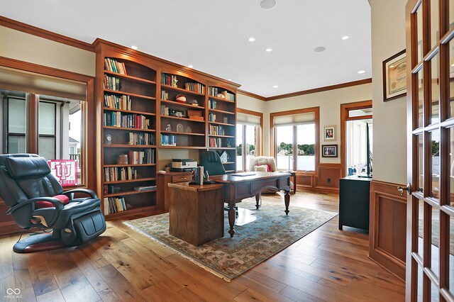 office area with ornamental molding and hardwood / wood-style floors