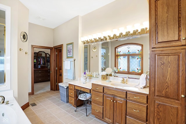 bathroom with vanity, a bathtub, and tile patterned floors