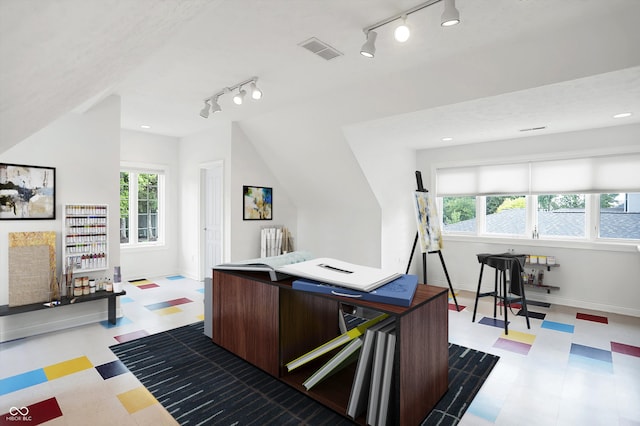 office space with a wealth of natural light, a textured ceiling, and rail lighting