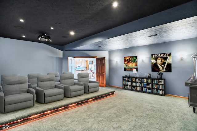 carpeted home theater with a textured ceiling