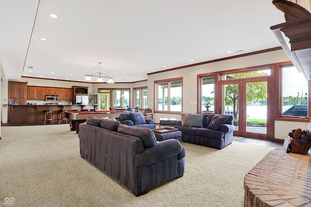 living room featuring french doors, light colored carpet, crown molding, and pool table