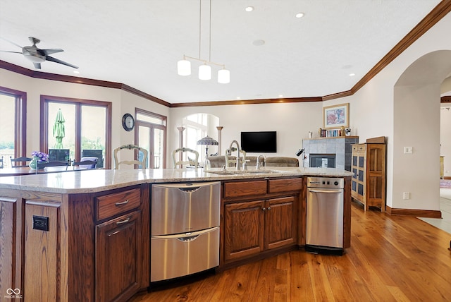 kitchen featuring a kitchen island with sink, a wealth of natural light, pendant lighting, and hardwood / wood-style floors