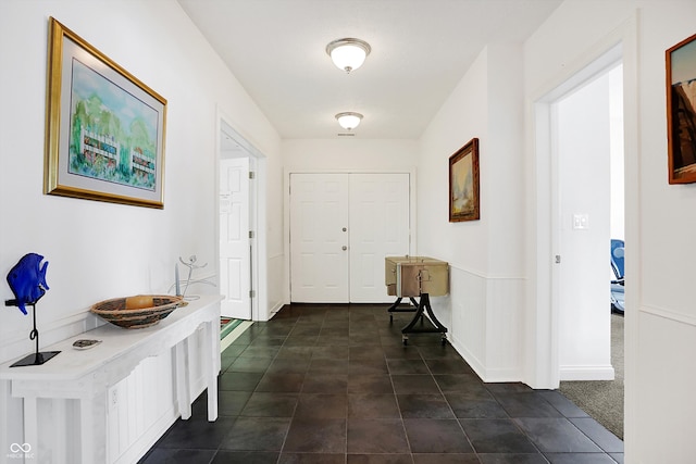 foyer entrance featuring dark carpet