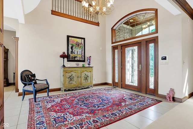 tiled entryway with a chandelier and a high ceiling