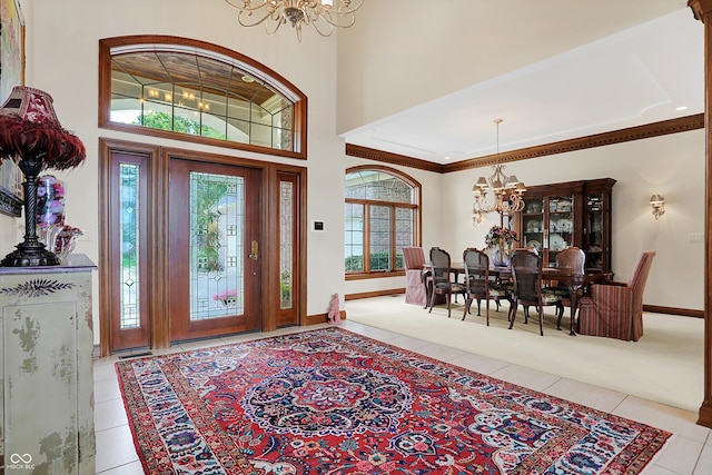 entrance foyer with a high ceiling, a chandelier, and light tile patterned floors