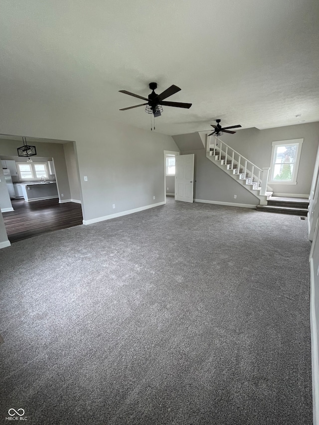 unfurnished living room with carpet floors and ceiling fan