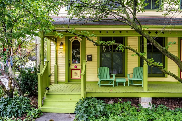 view of exterior entry featuring covered porch